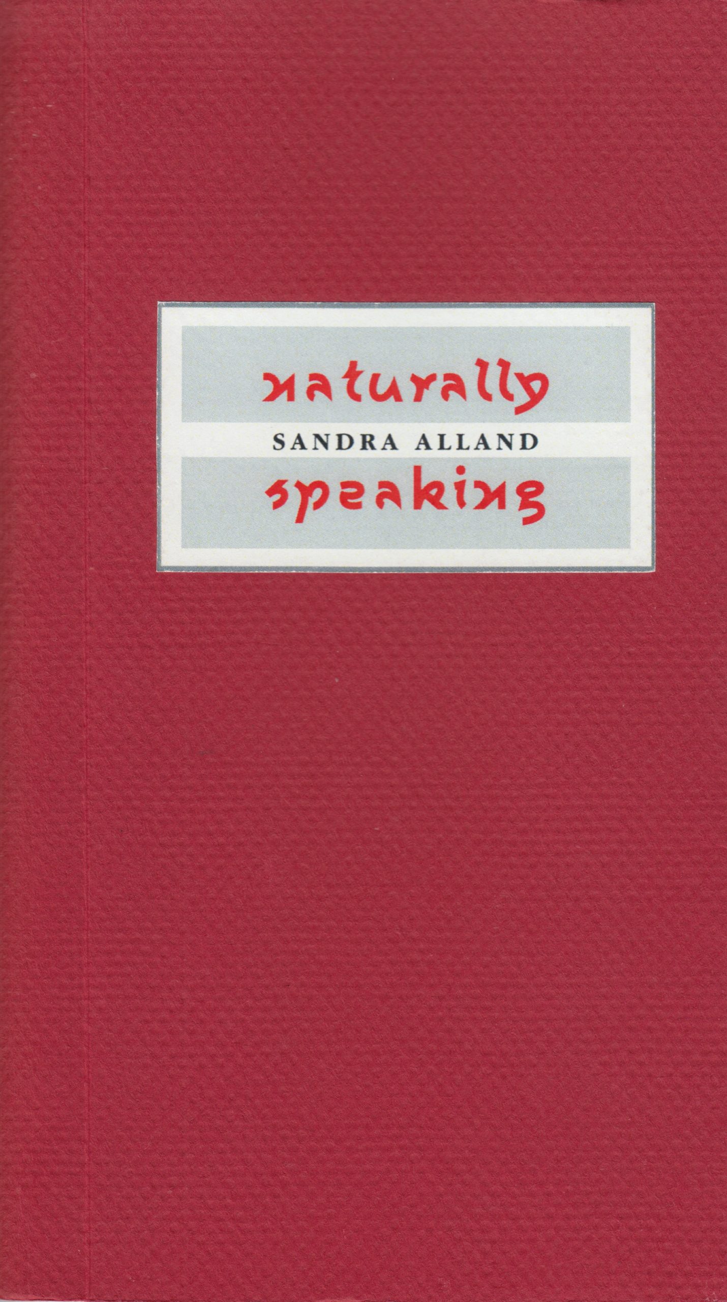 The cover of Naturally Speaking by Sandra Alland. The cover is red, with the title and author name encased in a white-gray frame. The book’s title is in a playful, almost hand-written font, whereas the author’s name is in a standard font. The red paper has a subtle raised checked pattern that invites touch.